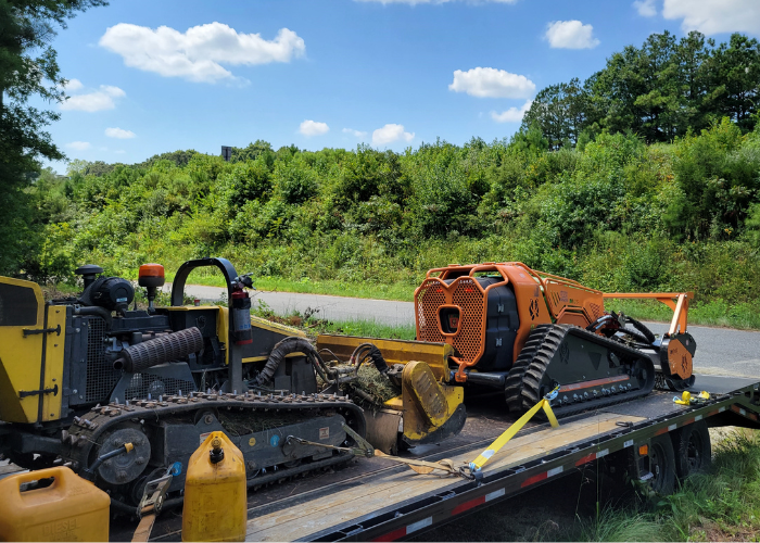 A remote-controlled mower working a steep hillside